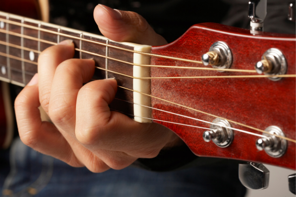 A close up of a guitar being played.