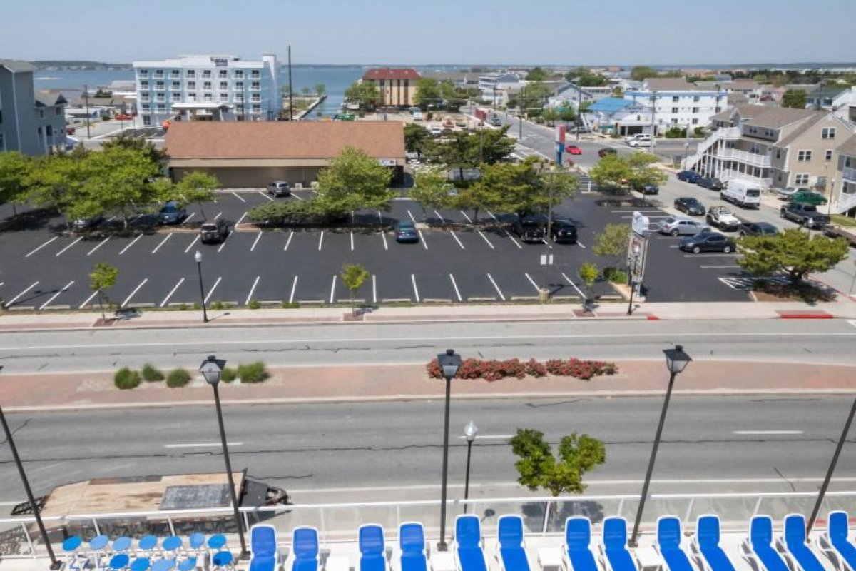 an aerial view of a parking lot and the ocean