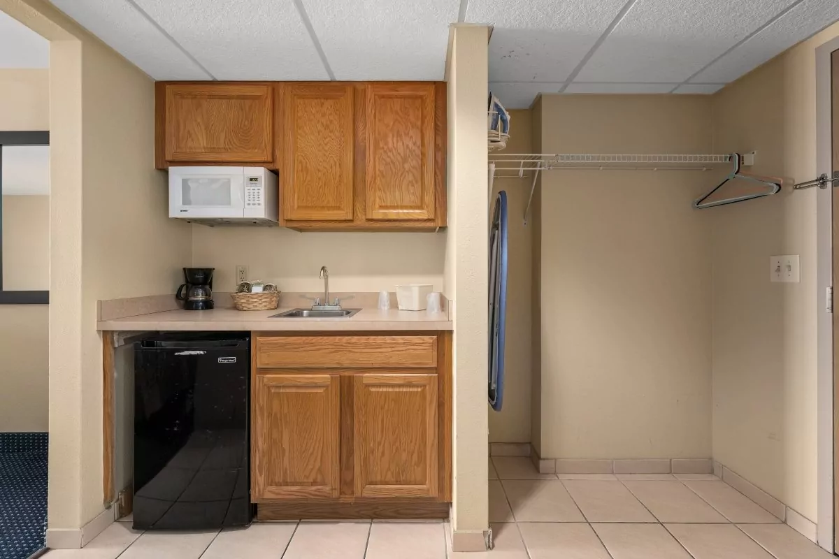 a kitchen with wooden cabinets and black appliances